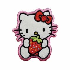 a hello kitty iron - on patch with a strawberry in it's hand and a bow around its neck