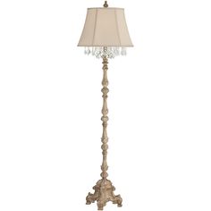 a floor lamp with a white shade on the top and a crystal beaded base