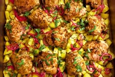 a casserole dish with chicken, pineapples and red onion garnishes