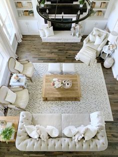 an overhead view of a living room with white furniture