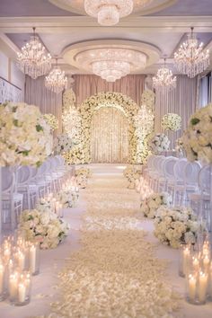 Luxury wedding aisle with white petals, florals, and chandeliers. Elegant Romantic Wedding Decor, Luxury Wedding Decor Backdrops, Classic Elegant Wedding Decor, Luxury Wedding Aisle, Romantic Elegant Wedding Theme, Royal Wedding Ideas, Boujee Wedding, Royalty Wedding Theme