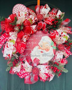 a red and white christmas wreath on a door