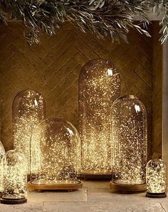 several glass vases sitting on top of a stone floor next to a fire place