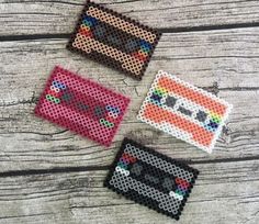 three different types of beaded coasters sitting on top of a wooden table next to each other