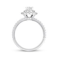 a white gold engagement ring with an oval diamond center