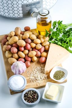 potatoes, parmesan cheese and other ingredients on a cutting board