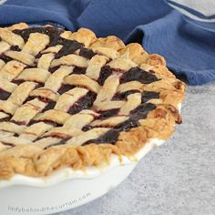 a blueberry pie sitting on top of a white plate