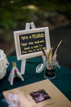 there is a sign on the table that says take a polaroid