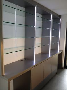 a row of glass shelves sitting next to each other on top of a counter in a room