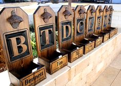 wooden signs are lined up on the side of a wall