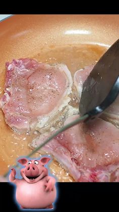 a person cutting meat into pieces with a knife and fork in a bowl next to a pig