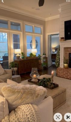 a living room filled with furniture and a flat screen tv mounted on the wall above a fire place