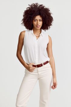 Our warm weather staple.The Signature Sleeveless Shirt is a classic for layering or to wear on its own. Narrow armholes mean bra won't peek through the side (and won't peek through the front either.) This fabric has a crepe-like pebbly texture and resists wrinkling. 

 Rochelle Behrens reimagined how shirts should fit and feel. Our patented No Gape® button technology, seamlessly designed into every shirt and shirtdress we design, eliminates blouse gape. Finally say bye bye blouse gape, hello The Shirt.

  
 * Poly Crepe
  
 * Made in Portugal 
 * Powered by our patented No Gape® button technology 
 *  Model is 5'9" wearing size S Classic Sleeveless Tops For Everyday, Classic Tank Top For Layering, Classic Sleeveless Tank Top For Summer, Classic Sleeveless Blouse For Summer, Classic Summer Tank Top For Layering, Classic Vest Top For Layering, Classic Summer Vest Tops, Classic Sleeveless Top For Daywear, Classic Summer Tank Top For Daywear