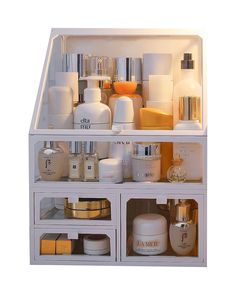 a white shelf filled with lots of different types of skin and body care products on top of each other