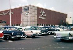 many old cars are parked in front of a building with a sign that says franklin & clark