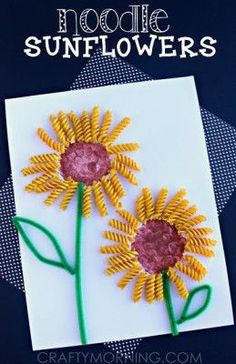 two sunflowers made out of pasta sitting on top of a white card