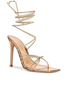 Find GIANVITO ROSSI Nappa Silk Strappy Heels In Metallic Gold on Editorialist. Gianvito Rossi Nappa Silk Strappy Heels in Metallic Gold Metallic leather upper with leather sole. Made in Italy. Wrap around ankle strap with tie closure. Square toe. Strappy design. Approx 100mm/ 4 inch heel. GIAN-WZ537. G32016-15RIC-NPS. About the designer: With footwear in his blood-his father Sergio contributedto the history of Italian footwear worldwide-Gianvito Rossi designs shoes, first and foremost, to accentuate a womans silhouette in a harmonious combination of proportion and graceful lines. A love for beauty, aesthetics and harmony of proportions guides the stylist in each of his creations, which are pure forms of design, far from excess and exaggeration and true to the never-shouted elegance thathas