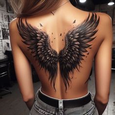 the back of a woman's body with black wings on it