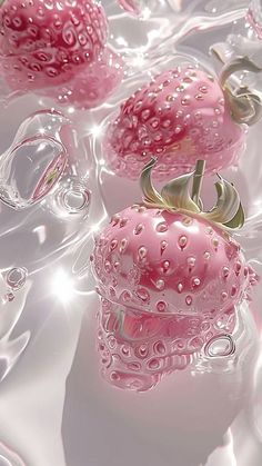 some pink objects are floating in water on a white tablecloth with bubbles and drops