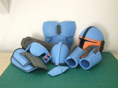 several pieces of blue leather sitting on top of a green mat next to each other