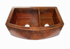 a large copper sink with two holes in the middle