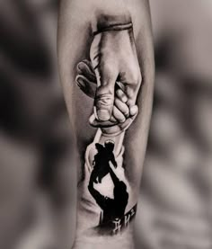 a black and white photo of two hands holding each other