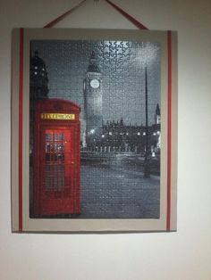 a red phone booth hanging on the wall