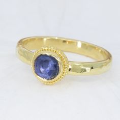 This beautiful 18K Treasure Gold ring, crafted with sunken treasure, showcases a majestic 0.83ct rose-cut blue sapphire. Enjoy the delightful shimmer of its water-ripple band, while its ancient feel adds a touch of mystery to any outfit. While I can make similar style rings, this one is one-of-a-kind owing to the irregular cut of the gem. Handcrafted in solid 18K gold made with 400 year-old sunken treasure recovered from the Caribbean. Size 7.25, but each ring comes with free sizing and FREE SHI Handmade Yellow Gold Sapphire Ring, Gold Sapphire Rings Hand Forged, Gold Sapphire Birthstone Ring With Rose Cut Diamonds, Gold Hand Forged Sapphire Ring, Hand Forged Gold Sapphire Ring, Hand Forged Blue Sapphire Ring Gift, Blue Hand Forged Rings For Anniversary, Hand Forged Blue Rings For Anniversary, Hand Forged Blue Sapphire Ring For Anniversary