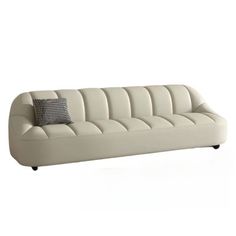 a white couch with two pillows on it's back and the seat upholstered