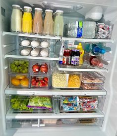 an open refrigerator filled with lots of different types of food and drinks in plastic containers