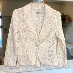 Adrienne Vittadini Lace Blazer Excellent Condition Single Front Button Ivory Color Fabric Has No Stretch Size M Armpit To Armpit: ~19” Length: ~21.5” If You Are Brand New To Poshmark, Use Code Cem_poshmark At Checkout For $10 Off Your First Order. Feminine Cream Outerwear For Formal Occasions, Feminine Formal Cream Outerwear, Feminine Cream Formal Outerwear, Fitted Cream Feminine Outerwear, Beige Wedding Outerwear With Buttons, White Wedding Outerwear With Button Closure, Spring Wedding Blazer With Button Closure, Elegant Fitted Winter White Blazer, Elegant White Button-up Blazer