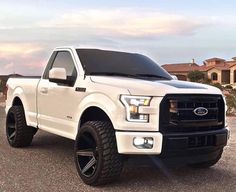 a white truck parked in a parking lot