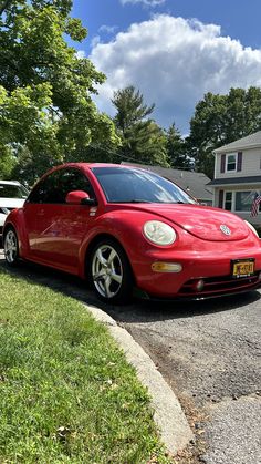 a red car parked in front of a house