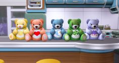 five teddy bears sitting on top of a counter next to each other in a kitchen