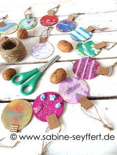 some crafting supplies are laid out on a table with scissors and twine rope