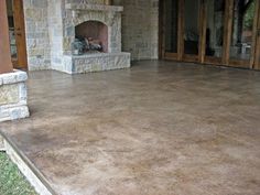 an outdoor patio with stone fireplace and steps