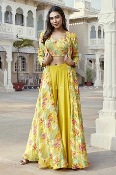 Floral Fusion: Elegant Yellow Indo-Western Set  Description: Brighten up your wardrobe with this stunning yellow Indo-Western outfit featuring a vibrant floral print. This coordinated set blends modern style with traditional charm, perfect for festive occasions or casual gatherings. The flowing silhouette adds grace while the bold colors bring a cheerful vibe. Ideal for the fashion-forward woman who loves to stand out!  Hashtags: #IndoWesternFashion #FloralOutfit #YellowOutfit #EthnicChic #TraditionalWithATwist #FestiveFashion #StyleInspiration #ElegantAttire Western Party Wear Dresses, Crop Top Palazzo, Palazzo Outfit, Western Party Wear, Gopi Vaid, Palkhi Fashion, Western Dresses For Women, Floral Print Jacket, Silk Crop Top