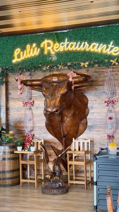 the entrance to an italian restaurant with a statue of a bull