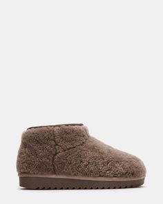 Introducing CABIN, the comfy bootie that will keep your feet warm and comfortable all winter long! With faux shearling lining, these boots are both soft and stylish. The easy slip on design makes them perfect for everyday wear. Don't miss out on this must-have addition to your wardrobe! 1 inch heel height 13.5 inch shaft circumference 3.75 inch shaft height Faux shearling upper material Faux shearling lining Faux shearling sock Synthetic sole Imported Cozy Boots With Plush Lining And Round Toe, Cozy Winter Boots With Plush Lining, Casual Fluffy Boots With Round Toe, Comfortable Fall Boots With Faux Fur Lining, Fluffy Casual Winter Boots, Casual Fluffy Winter Boots, Winter Slip-on Boots With Faux Fur Lining, Comfortable Shearling Boots For Winter, Casual Shearling Boots With Plush Lining