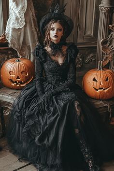 a woman in a black dress sitting on a bench with pumpkins