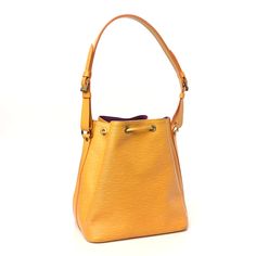 This is an authentic LOUIS VUITTON Epi Petit Noe in Tassil. This chic bucket-style bag is crafted of Louis Vuitton's signature textured Epi leather in a sunny yellow. The shoulder bag features a smooth leather cinch cord with gold eyelets and an adjustable smooth leather shoulder strap with gold buckles. The top is open to a spacious purple microfiber interior. Louis Vuitton Noe Bag, Pumpkin Monogram, Louis Vuitton Empreinte, Lv Monogram, Sunny Yellow, Louis Vuitton Shoulder Bag, Weekender Tote, Authentic Louis Vuitton, Smooth Leather