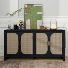 a black cabinet with rattan doors and gold handles in front of a white wall