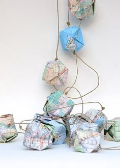 a bunch of origami cubes that are on a string and tied to the wall