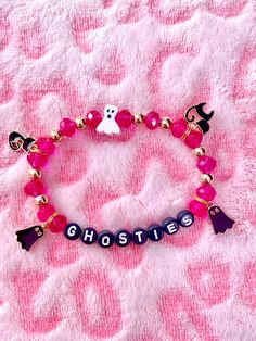 Halloween Charm Bracelets for the Pinkaween! Add a touch of spooky charm to your Halloween attire with our adorable Ghosties with Black Cats charm stretchy bracelet.  It's the perfect accessory to complete your festive look. Handcrafted with love, available now on Etsy.  This Halloween bracelet is the ideal gift, infusing spooky fun into any outfit. Its playful charms capture the Halloween spirit, making it a delightful and stylish present. If you have any questions please message me. All Sales Themed Adjustable Bracelets For Parties, Fun Adjustable Jewelry For Halloween, Hhn Bracelets, Handmade Bracelets For Halloween Party, Adjustable Bracelets For Halloween Party, Adjustable Red Beaded Bracelets For Halloween, Pastel Halloween Bracelets, Halloween Party Beaded Bracelets, Spooky Halloween Bracelets For Gift