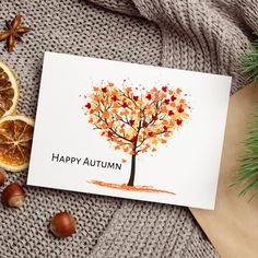 an autumn card with the words happy autumn on it next to sliced oranges and nuts