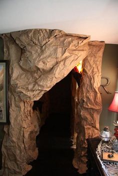 a room that has some kind of cave on the wall and lights in the doorway