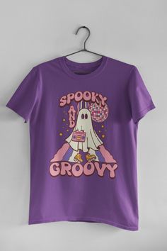 🖤 Product Details:- 100% Soft Ring-Spun Cotton- Light fabric that runs true to size- Unisex- Made in the USA 🇺🇸 🖤 Description:Get ready to turn heads this Halloween with our Spooky And Groovy, Retro Halloween T-Shirt! This funky, vintage-inspired tee is a perfect addition to your October wardrobe, blending nostalgia with a dash of eerie charm. You'll be the life of the party in this stylish and one-of-a-kind shirt, ideal for all the ghoul-friends and party monsters out there. Unleash your in October Wardrobe, Party Monsters, Groovy Retro, Monster Party, Life Of The Party, Retro Halloween, Royal Purple, Halloween T Shirt, Cotton Lights