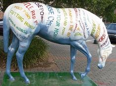 a statue of a horse with words written all over it's body and neck