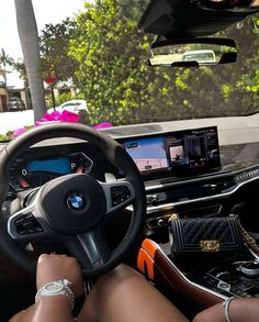 a woman driving a car with her hands on the steering wheel