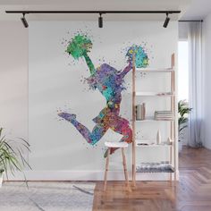 a woman running in the air with colorful paint splatters on it wall mural